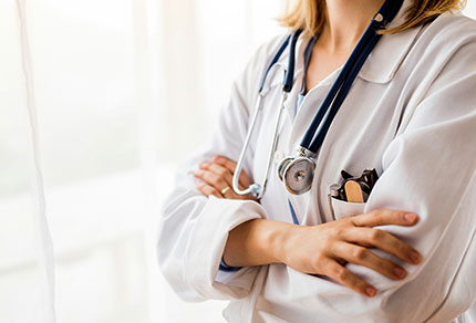 A physician standing with their arms crossed. 