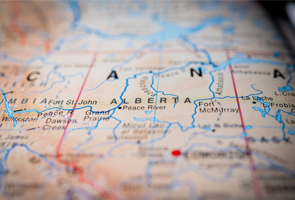 A paper map of Canada with Alberta in focus.