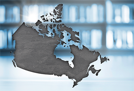 Silhouette of a map of Canada set against a blurred background of shelves filled with books.
