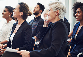 An audience of business professionals attending a seminar.
